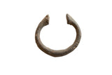 Antique African bronze alloy manilla cuff bracelet, C-shaped with rugged, dark patina.