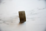Side profile of an antique African bronze cuff showing its detailed, hand-etched line work.