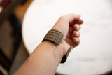 Antique African bronze cuff bracelet shown on-wrist to feature its scale and fit.