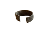 Antique African bronze cuff bracelet with a horizontal stripe design and a dark, aged patina.