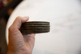 Side view of the antique bronze cuff highlighting its thick, ridged construction and patina.