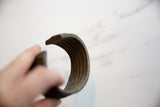 Ridged interior and aged patina of a handmade antique African bronze cuff.