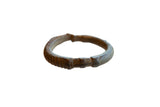 Antique African bronze cuff bracelet with ribbed geometric detailing and an aged patina.