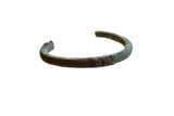 Antique African copper cuff bracelet with incised geometric detailing and a rich patina.