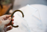 The open C-shape and detailed terminal of an antique African copper cuff.