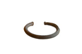 Antique African bronze cuff bracelet with handcrafted striped details and an aged patina.