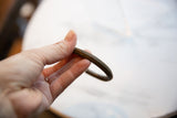 Finely striped texture and aged bronze patina on an antique cuff bracelet.