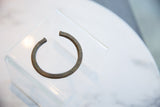 Collectible antique African bronze bracelet with an open cuff and textured surface.