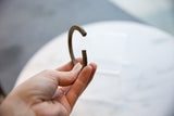 Antique African bronze cuff bracelet held to demonstrate its open form and scale.