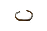 Antique African bronze cuff bracelet with a hand-carved striped texture and rich patina.