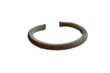 Antique African copper cuff bracelet with textured geometric details and a rich, time-softened patina.