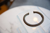 Angled view of the antique African copper cuff showing its open shape and rich patina.