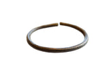 Antique African bronze bracelet with a dark oxidized patina and faded incised detailing.