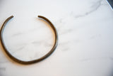 Vintage African bronze artifact's open cuff shape and handmade texture.