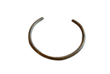 Vintage African bronze artifact in an open circular form with an aged patina.