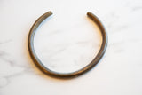 Vintage African Bronze Artifact with a dark, time-worn patina and textured surface.