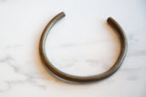 Overhead view of the vintage African bronze artifact, showing its open form and aged metal patina.