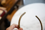 Aged patina on the smooth, rounded tip of the vintage bronze artifact.