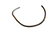 Vintage handmade African bronze artifact in a C-shape with a dark, aged patina.