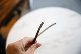 Slender profile and dark, aged surface of the vintage bronze artifact.