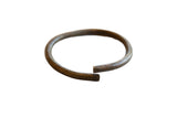 Vintage African bronze artifact, a handmade open ring with a dark, aged patina.