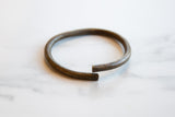 Angled view showing the open form and aged patina of the vintage bronze artifact.
