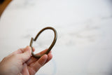 Vintage African bronze artifact held in hand to illustrate its scale and finish.