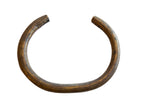 Vintage African bronze artifact with a dark, textured patina and open C-shape.