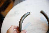 Close-up detail of the vintage African bronze artifact's aged and pitted texture.
