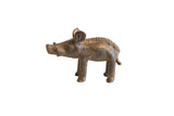 A collectible vintage African bronze boar sculpture with a textured back and dark, aged patina.