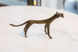 Side view of the vintage African bronze cheetah, highlighting its unique handmade texture.