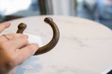 Antique bronze snake cuff bracelet held to show its scale and etched texture.