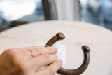 Antique African bronze cuff bracelet held in hand to demonstrate its scale and texture.