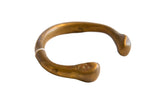 Antique African bronze snake cuff bracelet, displaying etched patterns and aged patina.