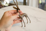 Detail of the vintage African bronze gazelle's body with rich patina and slender legs.
