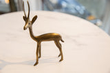 Handmade vintage African bronze gazelle displaying textured patina.