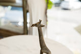 Profile view of the sculpted head and neck of a vintage African bronze giraffe.