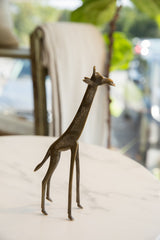 Handmade bronze giraffe collectible showcasing its slender profile and aged patina.