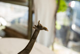 Detailed view of the vintage bronze giraffe's head, showing its expressive, handmade features.