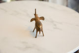 Vintage African bronze elephant, rear view detailing handmade texture and patina.