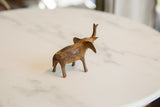 Handmade vintage African bronze alloy elephant, showing textured back and aged patina.