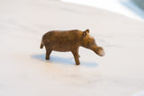 Profile view of a vintage bronze hippo showing its simple, handmade form.