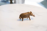 Profile view of a vintage African hippo sculpture with a textured bronze alloy patina.