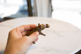 Small vintage bronze African hippo held in hand to show its collectible scale.