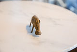 High-angle view of a vintage bronze hippo's face, highlighting its charming, simple form.