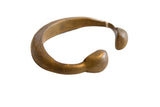 Antique African bronze snake cuff bracelet with a time-softened patina and rounded ends.