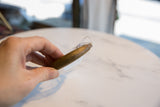 A side view of the antique bronze cuff's substantial, rounded profile.