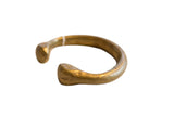 Antique African bronze snake cuff bracelet with stylized heads and a rich, time-softened patina.