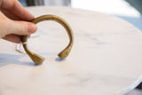 Antique bronze snake cuff bracelet showing the aged patina on its handcrafted, open design.