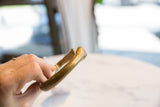 Antique bronze snake cuff held to show its smooth finish and time-worn patina.